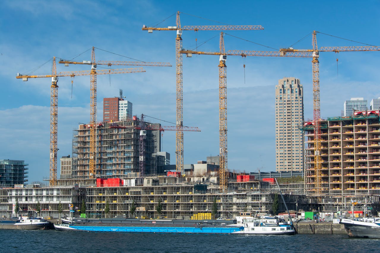 A modern construction site with multiple cranes and buildings in progress.